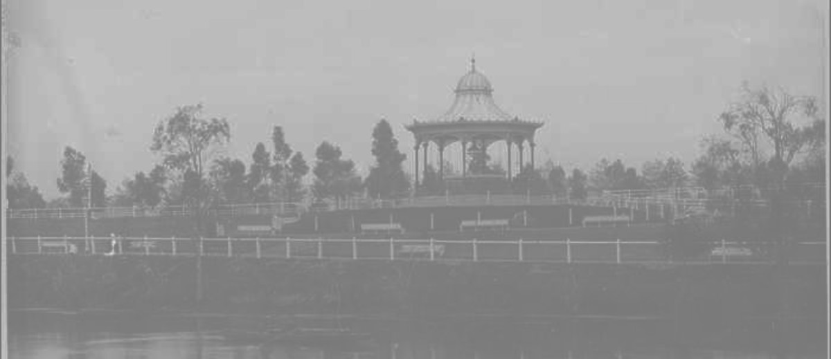 Image: A rotunda sits on a hill in a landscaped park on the bank of a river