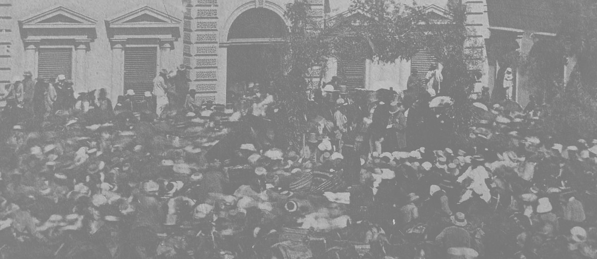 Image: crowd of people in front of stone building