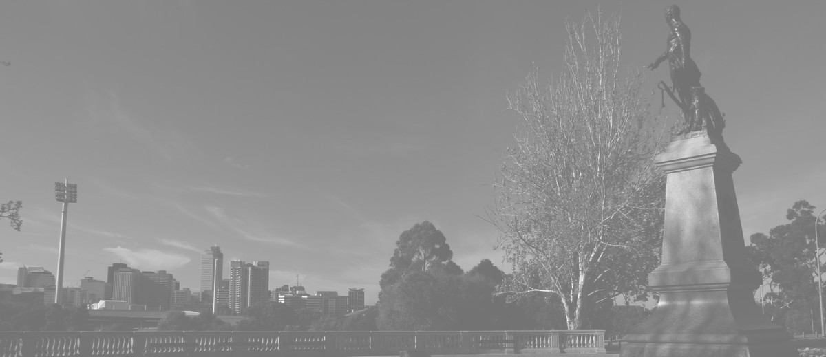 Image: bronze sculpture with city in background