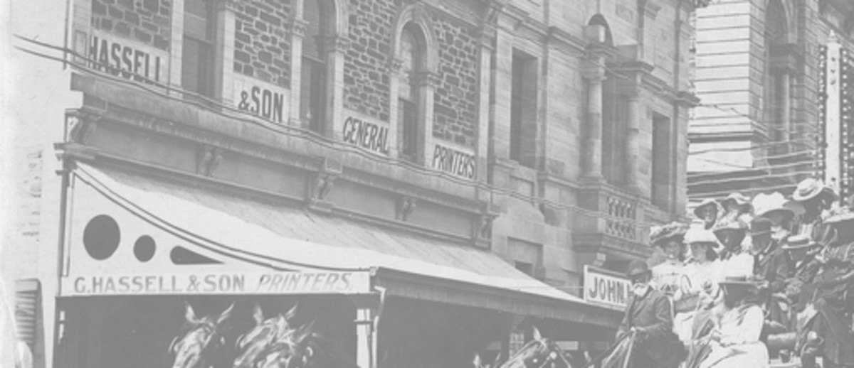 Image: two carriages and groups of people out front of a building. Building signed "General Printing Office" "Hassell & Son"  