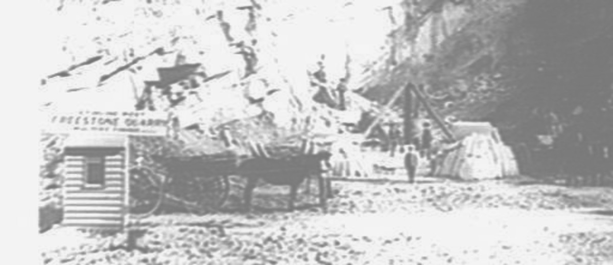 Image: Photo of a quarry with horse and carts and workmen  