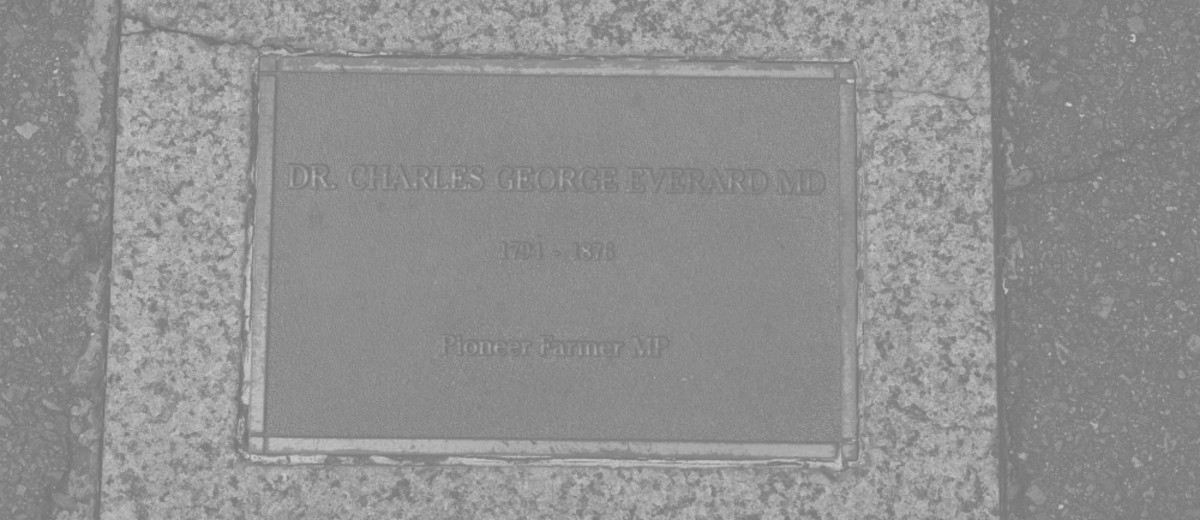 Bronze plaque set in pavement, inscribed with information about Dr Charles George Everard