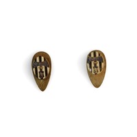 Image: two small metal pins in teardrop shape with black and white stripes