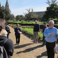 Image: man talking to group of people outside