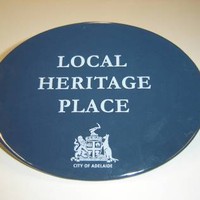 Image: blue plaque with logo and text 